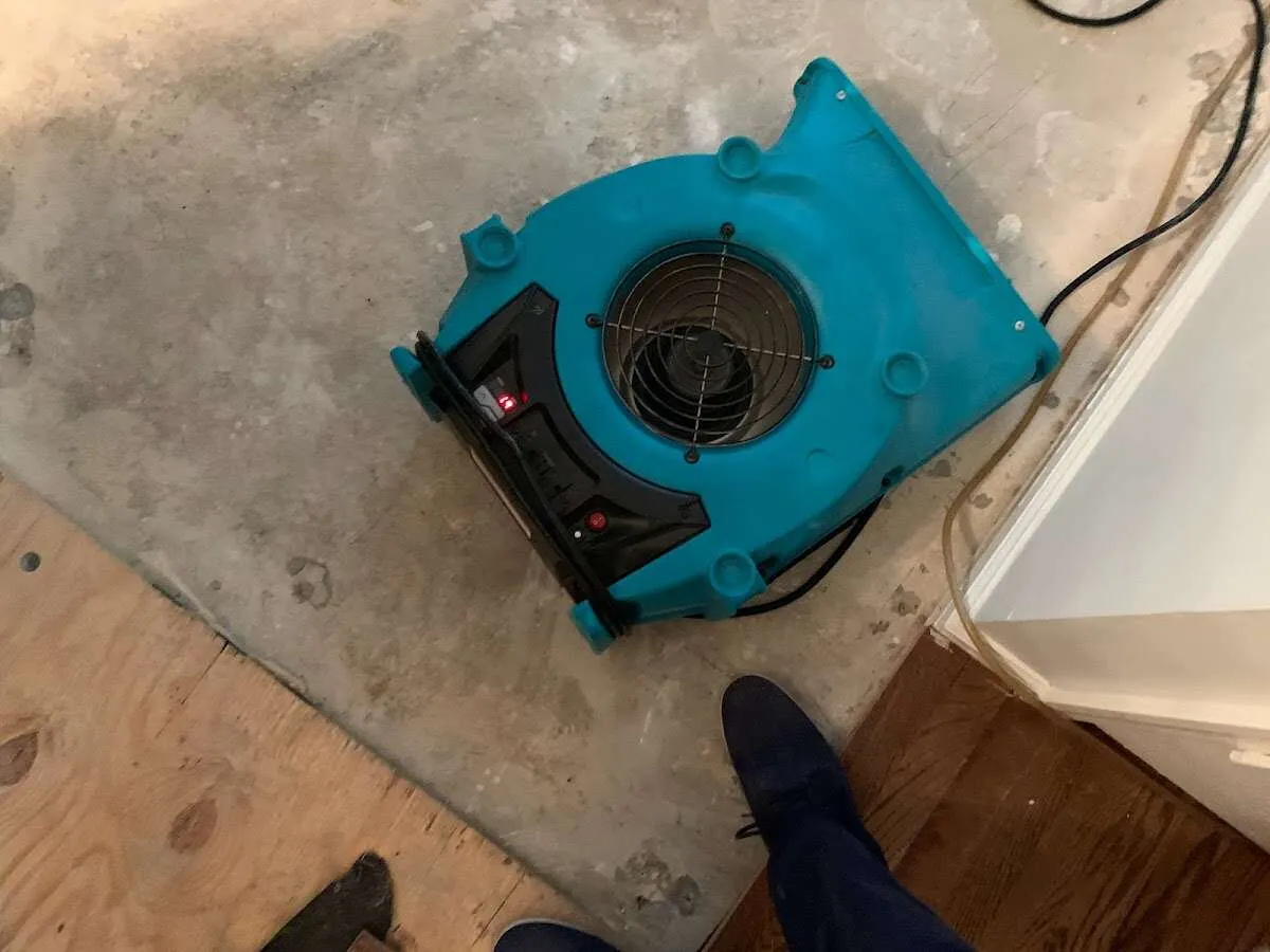 Air mover drying subfloor during Leak Detection & Repair in Poquoson